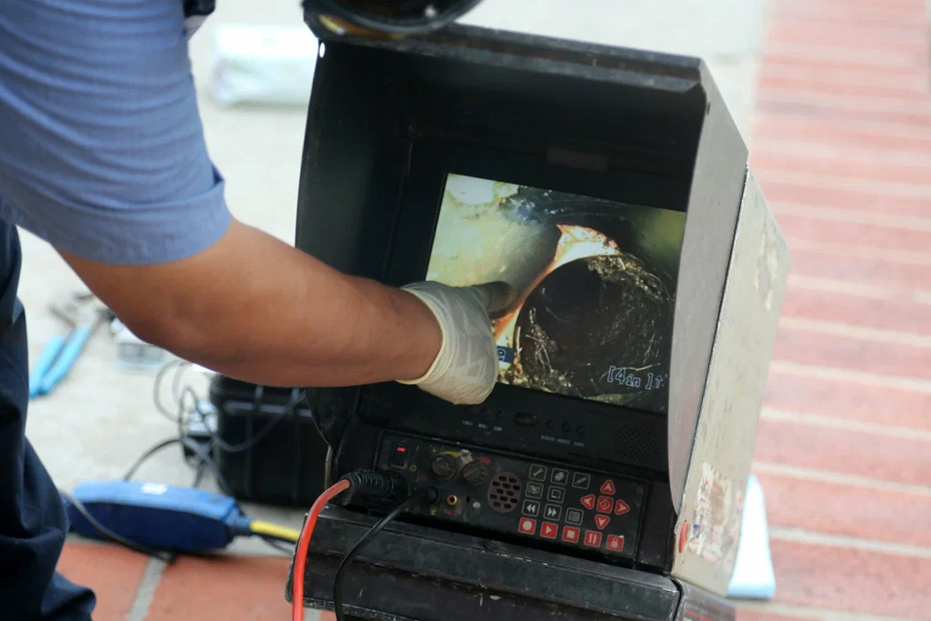 Technician viewing a drain inspection camera in San Diego